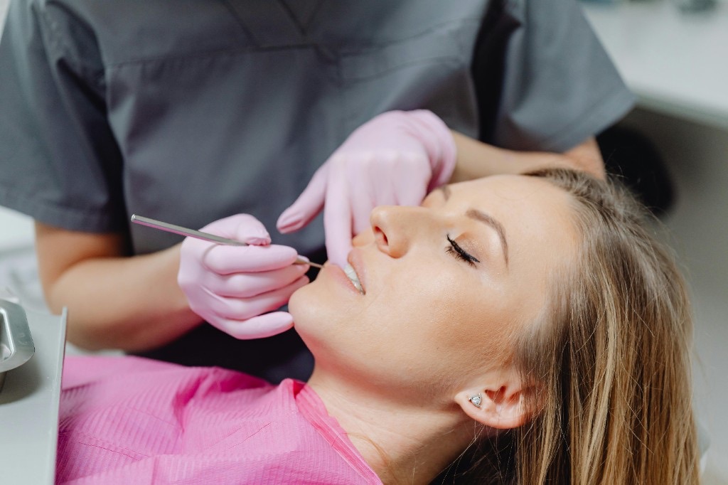 Dentist examining a young patient's teeth at a routine check-up